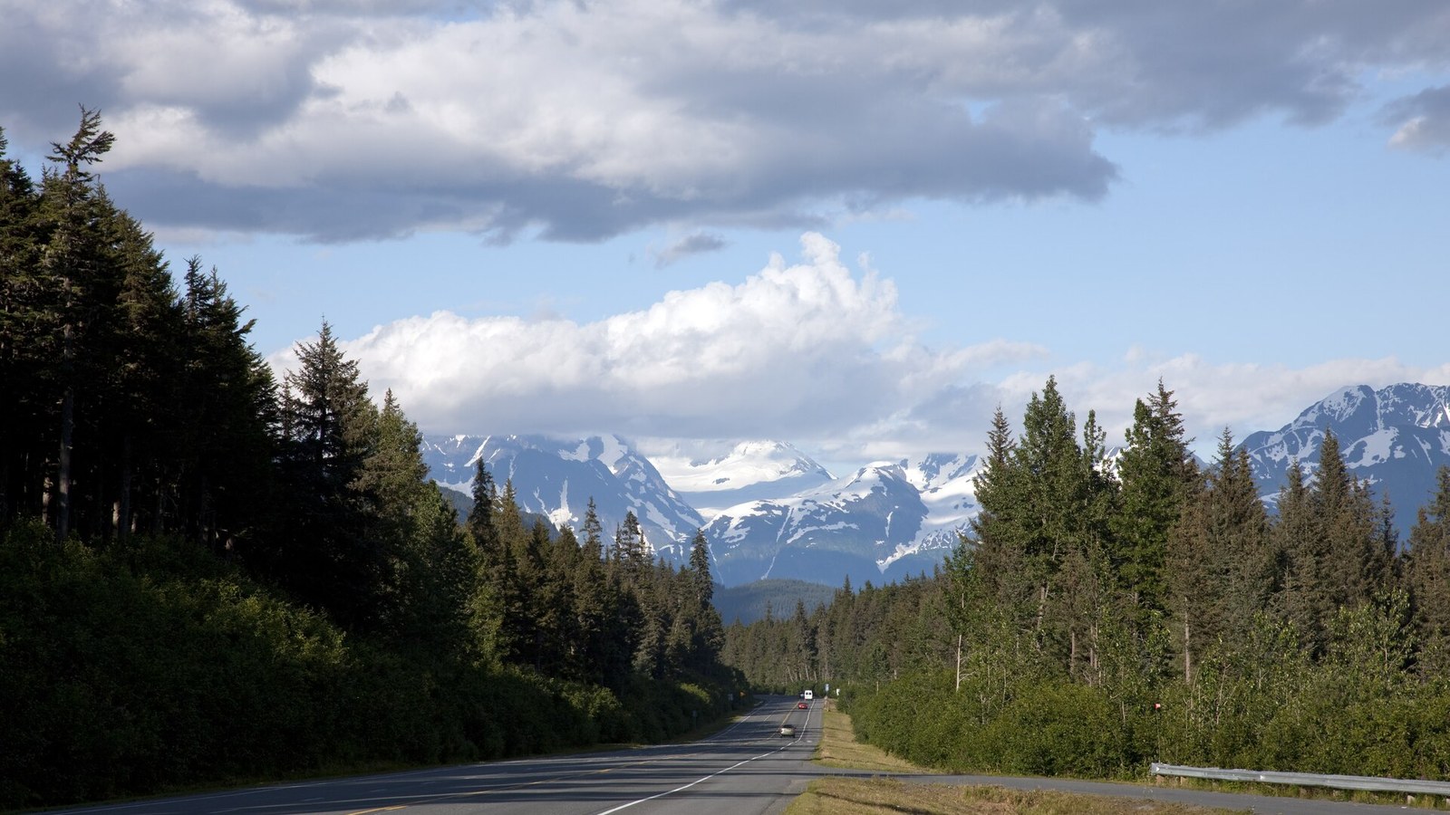 The Seward Highway running toward snow-capped mountains through the Chugach National Forest